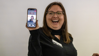 Woman holding phone with Civic video call representative