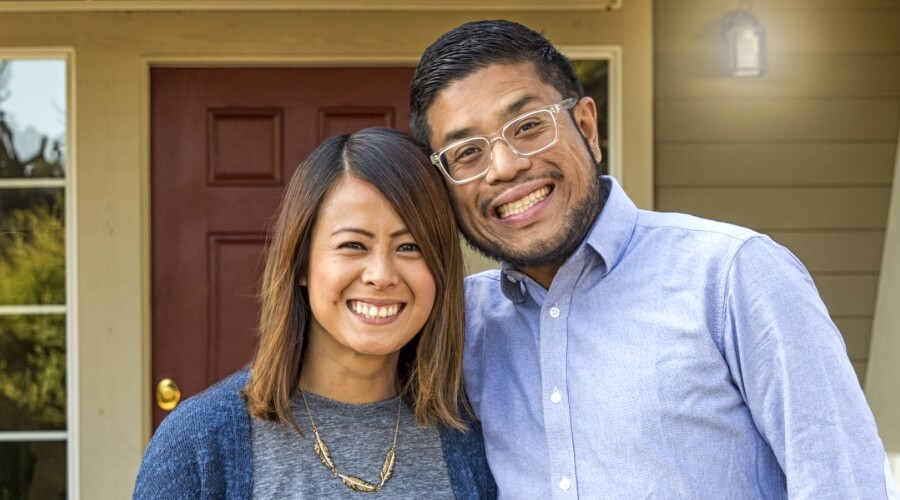 A couple standing in front of a home in North Carolina, where Civic Credit Union supports home buyers.