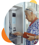 Woman of older age using a near by ATM to withdrawal money from her Bonus Checking account at Civic Credit Union.