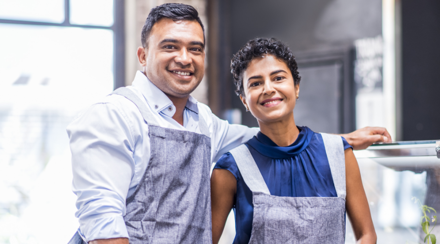 Married couple running their coffee shop and savings their money with a Business Choice Certificate from Civic.