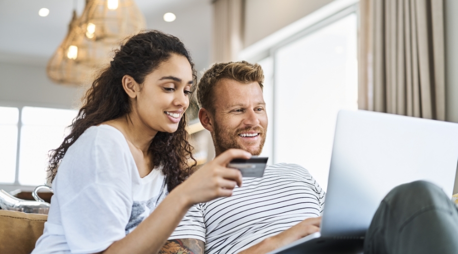 Smiling couple enjoying online shopping with Civic Classic Credit Card.