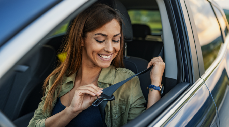 Woman bucking up to drive away in her used car financed by Civic Credit Union.