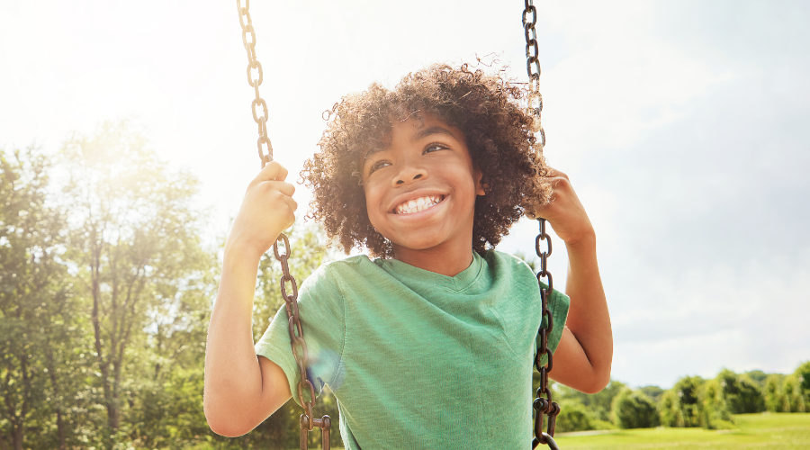 A YoungStar child saving for the future happily swinging outside.