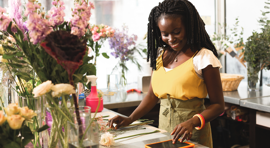 small business owner standing behind counter of her flower business