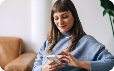 Smiling woman on her phone.