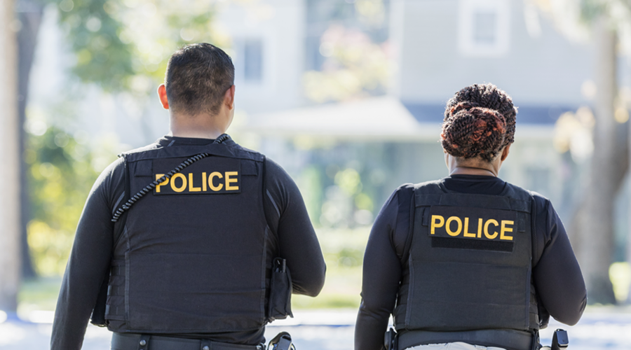 on male and one female police officers walking
