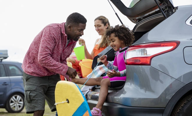 Family happily on vacation after refinancing their auto loan with Civic Credit Union.