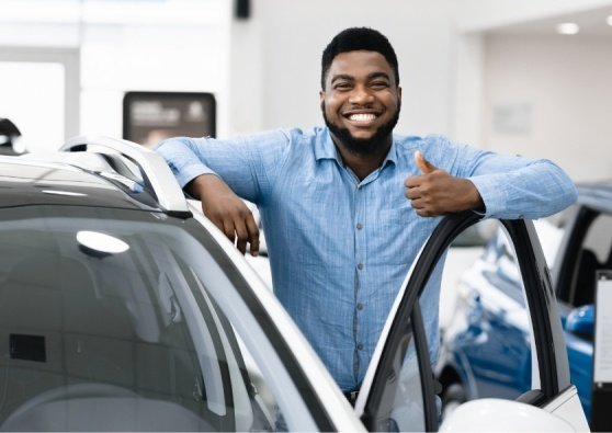 Man buying used car at dealership