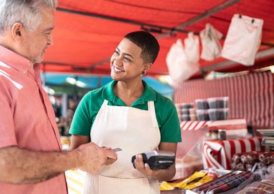 Man making a payment using a card in a Nonprofit vendor