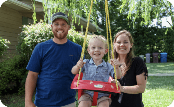 Civic family pushing toddler in swing