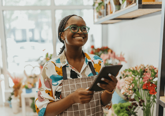 Florist store owner on a tablet, signing up for a Civic SEP IRA account. 