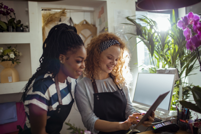 Small business owners looking at all the digital features provided by Civic.