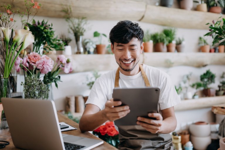 Male business owner looking at all the digital features offered at Civic.