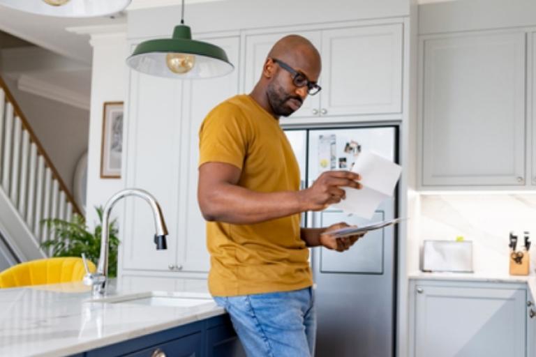 Man reviewing his mortgage payment hoping to find savings with a refinanced mortgage from Civic Credit Union.