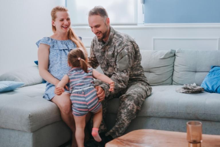 Military family celebrating the purchase of a VA loan through Civic Credit Union. 