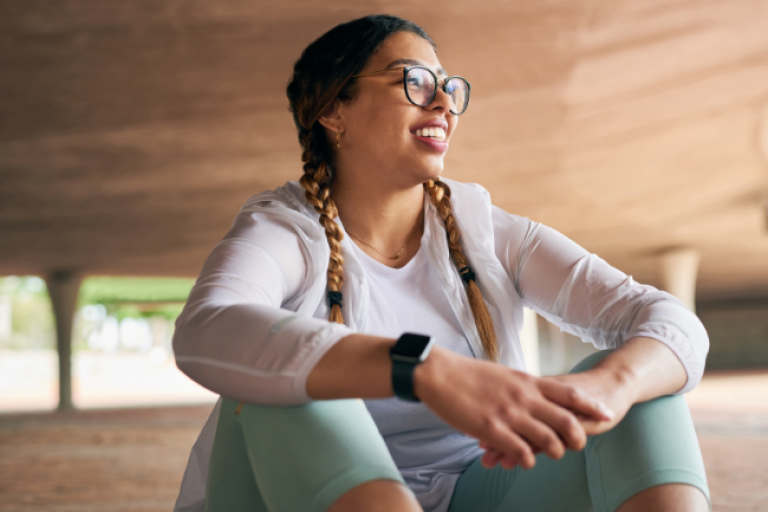 A young woman resting after a workout, discussing her Civic Roth IRA account.